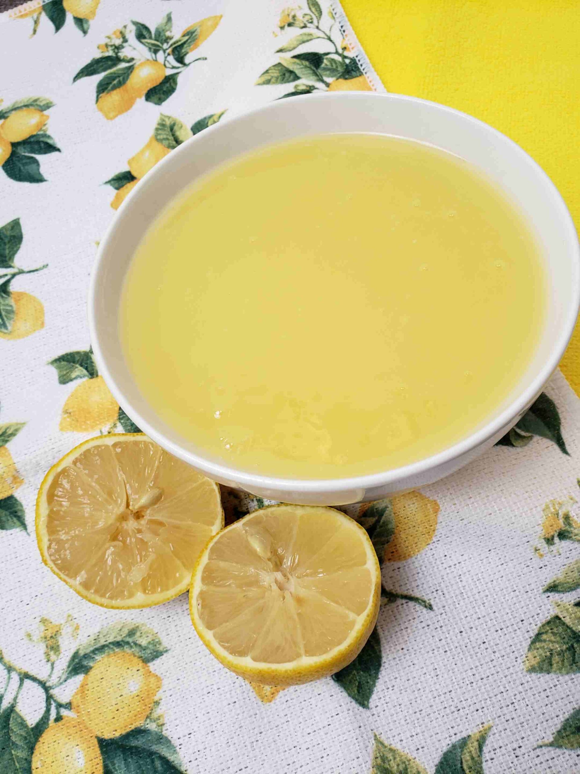 vintage lemon butter in white bowl with lemon tea towel under it