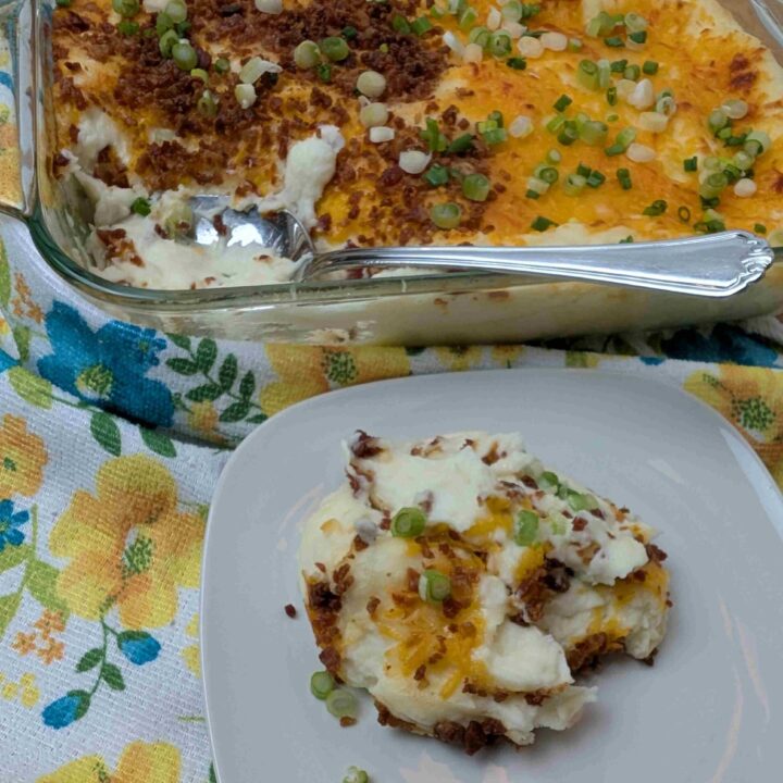 make ahead mashed potato casserole shown with a spoonful on a white dish