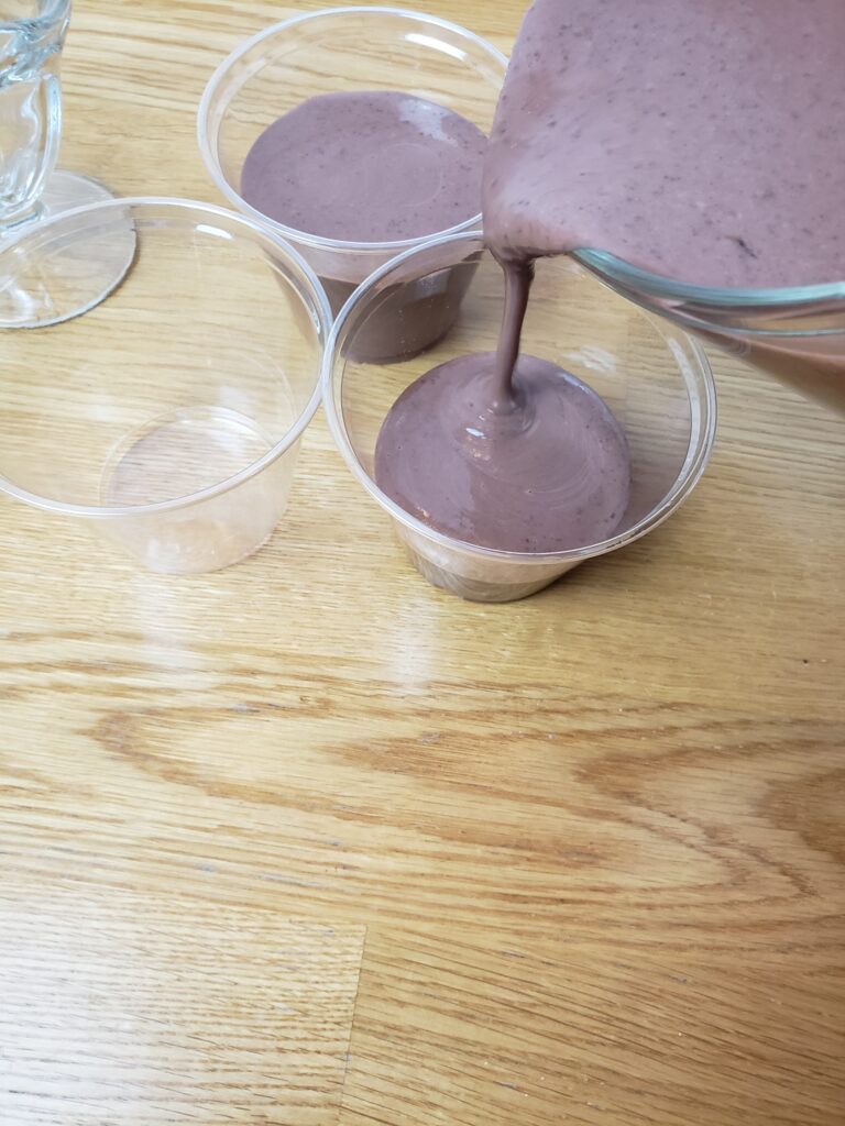 pouring pudding into cups
